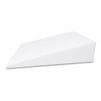 Bed wedge with white cover positioned on a bed, showing its gradual slope