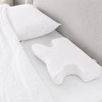 Advanced CPAP pillow with white cotton cover on a made bed
