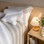 Original CPAP pillow with cotton cover on a bed, showing its butterfly shape