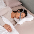 Travel CPAP pillow in use in a bedroom with a nasal mask fitted